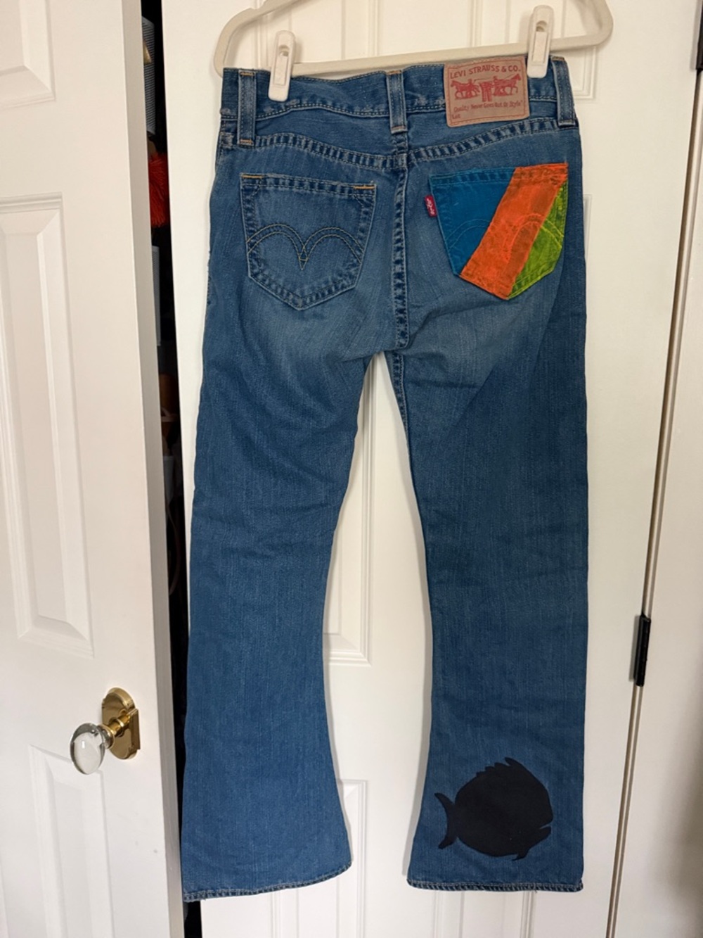 Custom hand painted women’s Levi’s Sunfish sailboat motif.